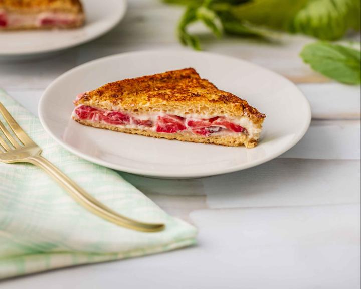 Stuffed strawberry French toast slice on white plate