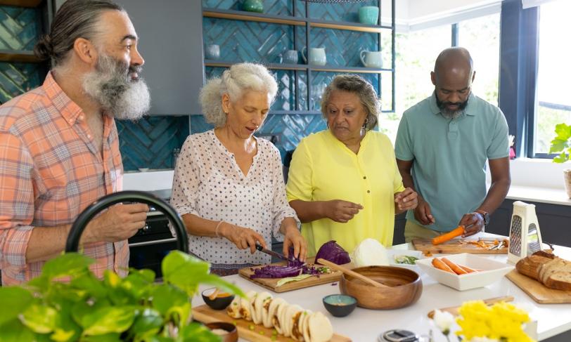 A group of people creating healthy cultural foods for a diabetes friendly meal to share