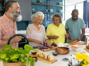 A group of people creating healthy cultural foods for a diabetes friendly meal to share