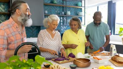 A group of people creating healthy cultural foods for a diabetes friendly meal to share