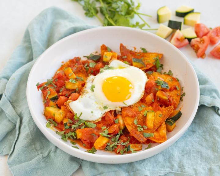 Chilaquiles with Sunny-Side-Up Eggs in a bowl with napkin for a diabetes friendly recipe