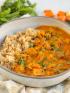 A bowl of richly spiced Indian butter chicken served with brown rice for a health Indian diet