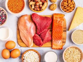 An assortment of protien rich foods like chicken, steak, salmon, almonds, eggs, and nuts. 