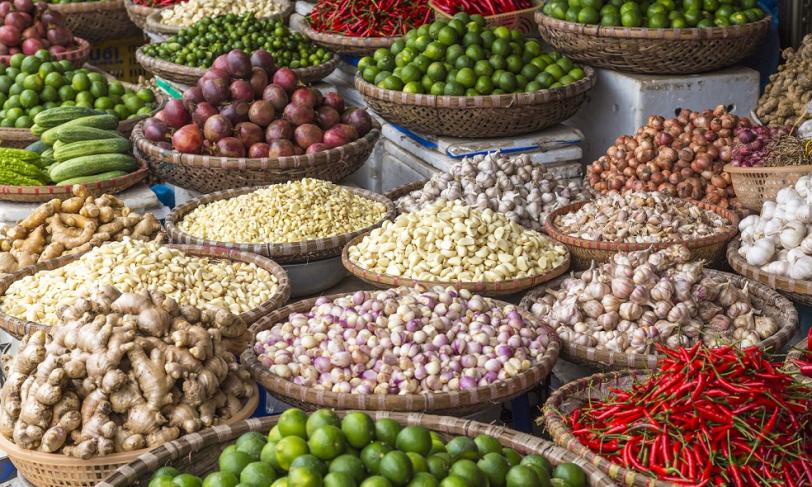 A variety of baskets filled with herbs and veggies from around the world for make global diabetes friendly recipes
